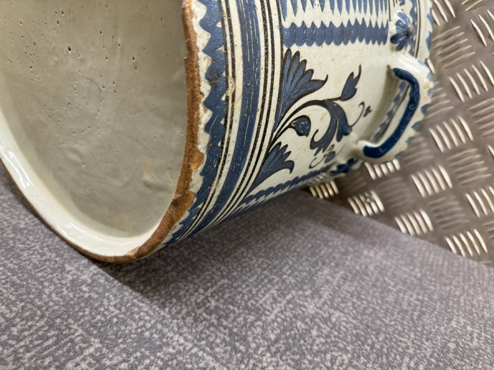 An 18th-century French Nevers faience ceramic orange pot decorated with hand-painted cobalt blue landscape motifs, geometric borders, and twin side handles. View VIII