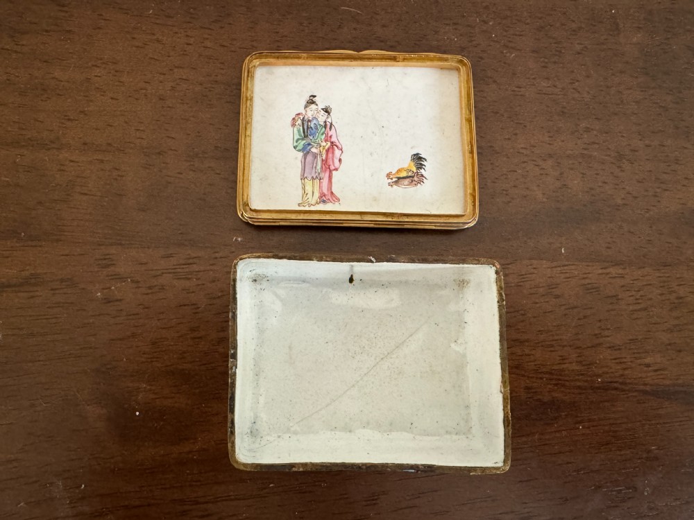 A rectangular 18th-century Chinese Beijing enamel snuff box decorated with a hand-painted scene of figures in traditional attire beside a river and framed by gilded metal. View VII