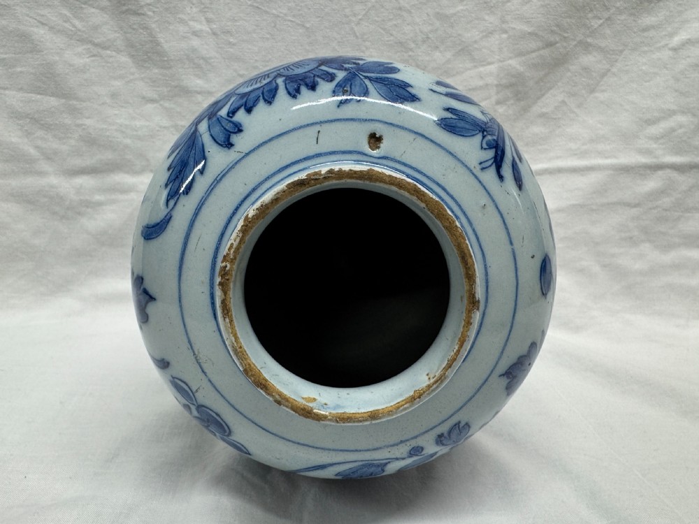 A blue and white tin-glazed earthenware baluster vase hand-painted with large floral and foliage motifs. View XII