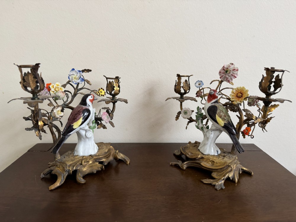 A pair of nineteenth-century French ormolu candelabra featuring hand-painted porcelain birds surrounded by gilt branches and floral mounts. View II