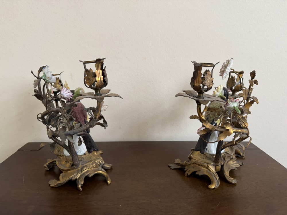A pair of nineteenth-century French ormolu candelabra featuring hand-painted porcelain birds surrounded by gilt branches and floral mounts. View V