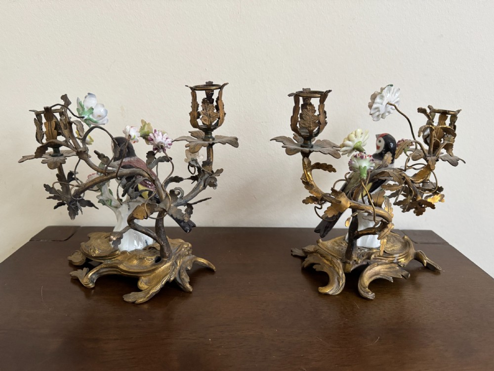 A pair of nineteenth-century French ormolu candelabra featuring hand-painted porcelain birds surrounded by gilt branches and floral mounts. View VI