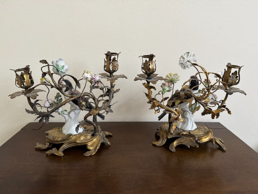 A pair of nineteenth-century French ormolu candelabra featuring hand-painted porcelain birds surrounded by gilt branches and floral mounts. View VII