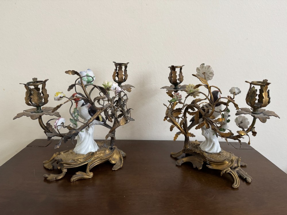 A pair of nineteenth-century French ormolu candelabra featuring hand-painted porcelain birds surrounded by gilt branches and floral mounts. View VIII