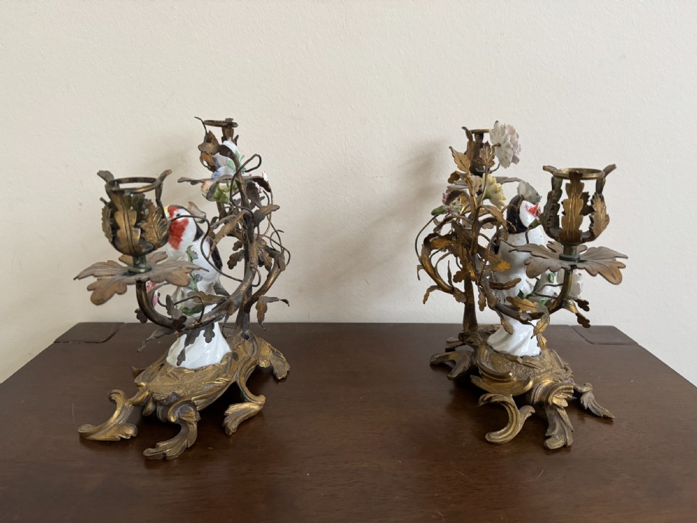 A pair of nineteenth-century French ormolu candelabra featuring hand-painted porcelain birds surrounded by gilt branches and floral mounts. View IX