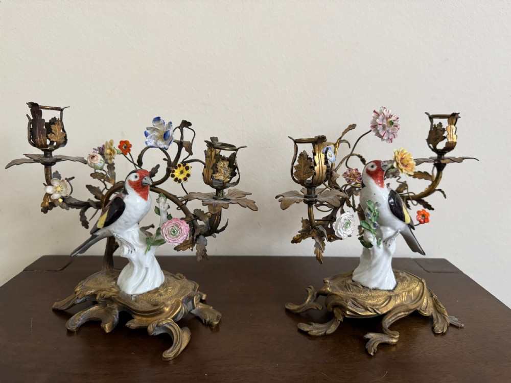 A pair of nineteenth-century French ormolu candelabra featuring hand-painted porcelain birds surrounded by gilt branches and floral mounts. View XI