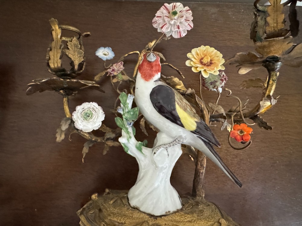 A pair of nineteenth-century French ormolu candelabra featuring hand-painted porcelain birds surrounded by gilt branches and floral mounts. View XIV