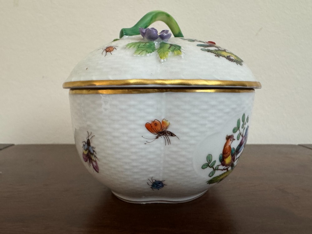 A white Dresden porcelain lidded bowl featuring relief basketweave moulding, hand-painted birds and insects, a branch handle, and gilt borders. View V