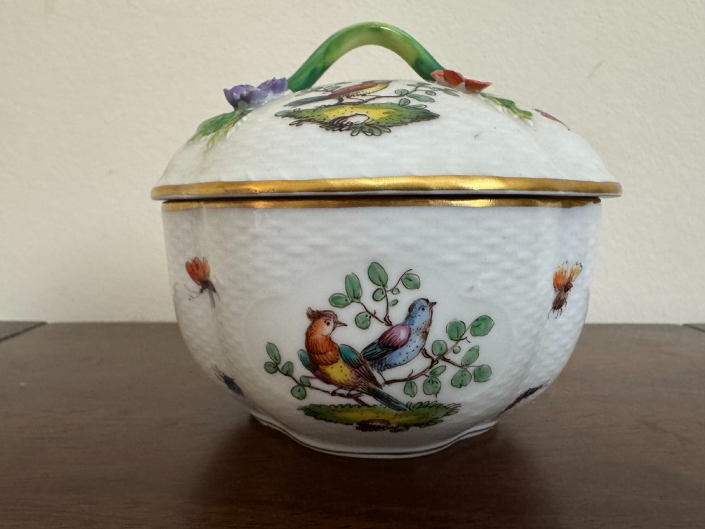 A white Dresden porcelain lidded bowl featuring relief basketweave moulding, hand-painted birds and insects, a branch handle, and gilt borders. View VI