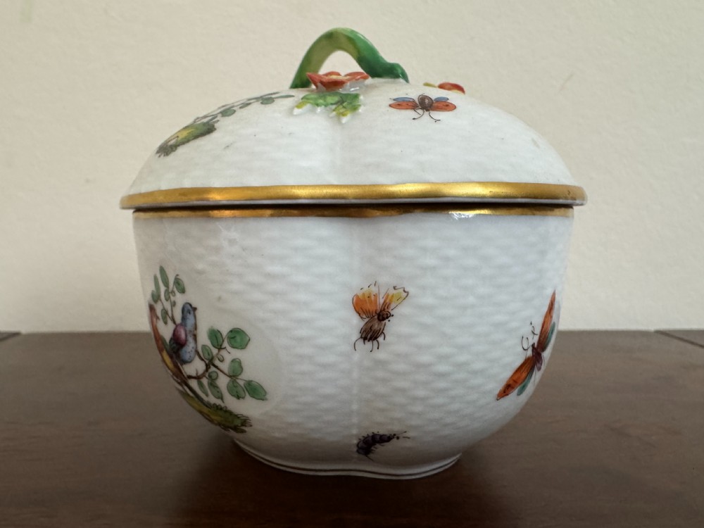 A white Dresden porcelain lidded bowl featuring relief basketweave moulding, hand-painted birds and insects, a branch handle, and gilt borders. View VII