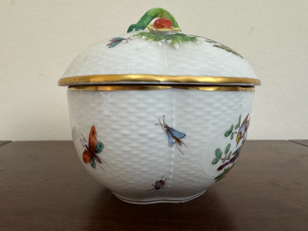A white Dresden porcelain lidded bowl featuring relief basketweave moulding, hand-painted birds and insects, a branch handle, and gilt borders. View IX