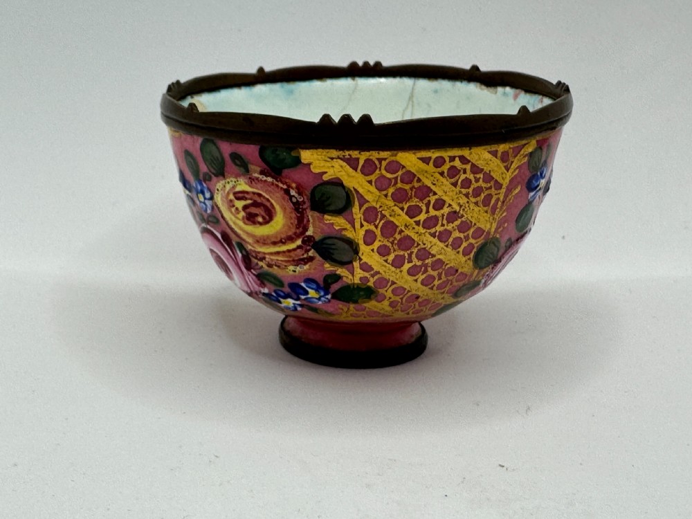 An 18th-century Limoges enamel salt bowl featuring hand-painted floral motifs on a pink ground with gilt lattice detailing and a dark metal rim. View II