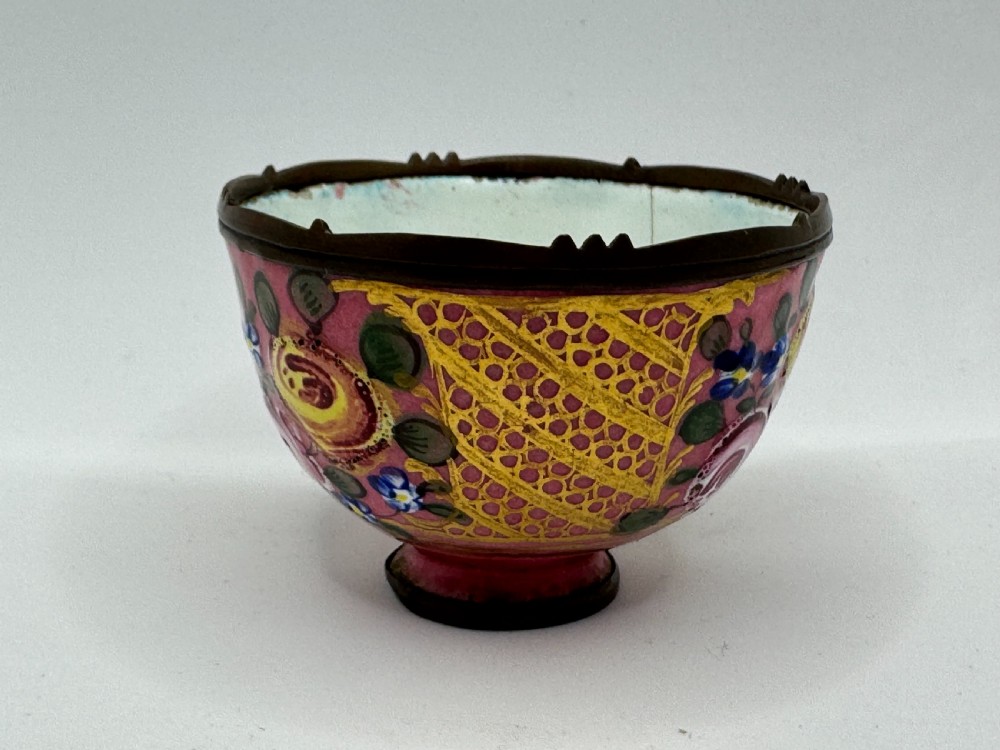 An 18th-century Limoges enamel salt bowl featuring hand-painted floral motifs on a pink ground with gilt lattice detailing and a dark metal rim. View VIII