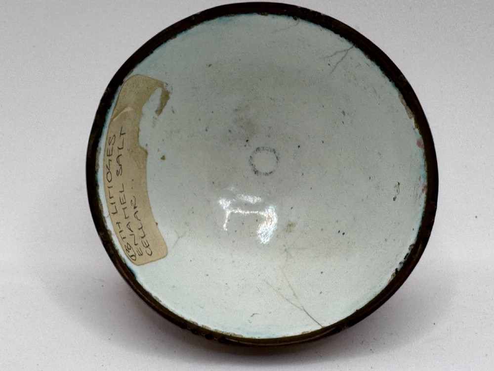 An 18th-century Limoges enamel salt bowl featuring hand-painted floral motifs on a pink ground with gilt lattice detailing and a dark metal rim. View XI