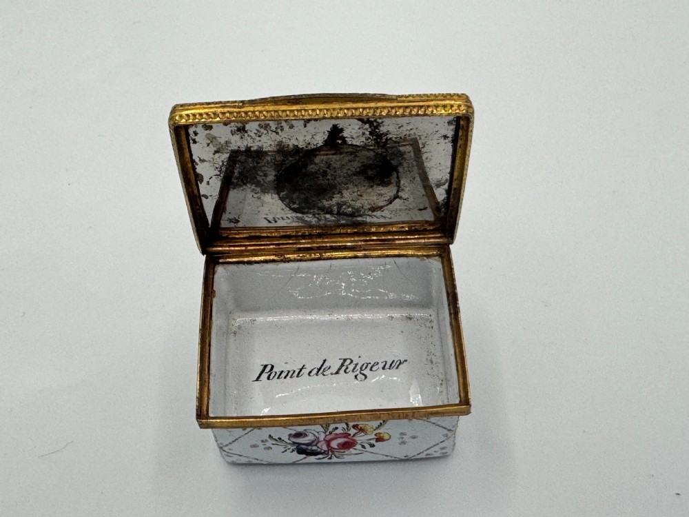 A small 19th-century rectangular enamel box decorated with a hand-painted pastoral scene surrounded by gilt scrollwork. View VII