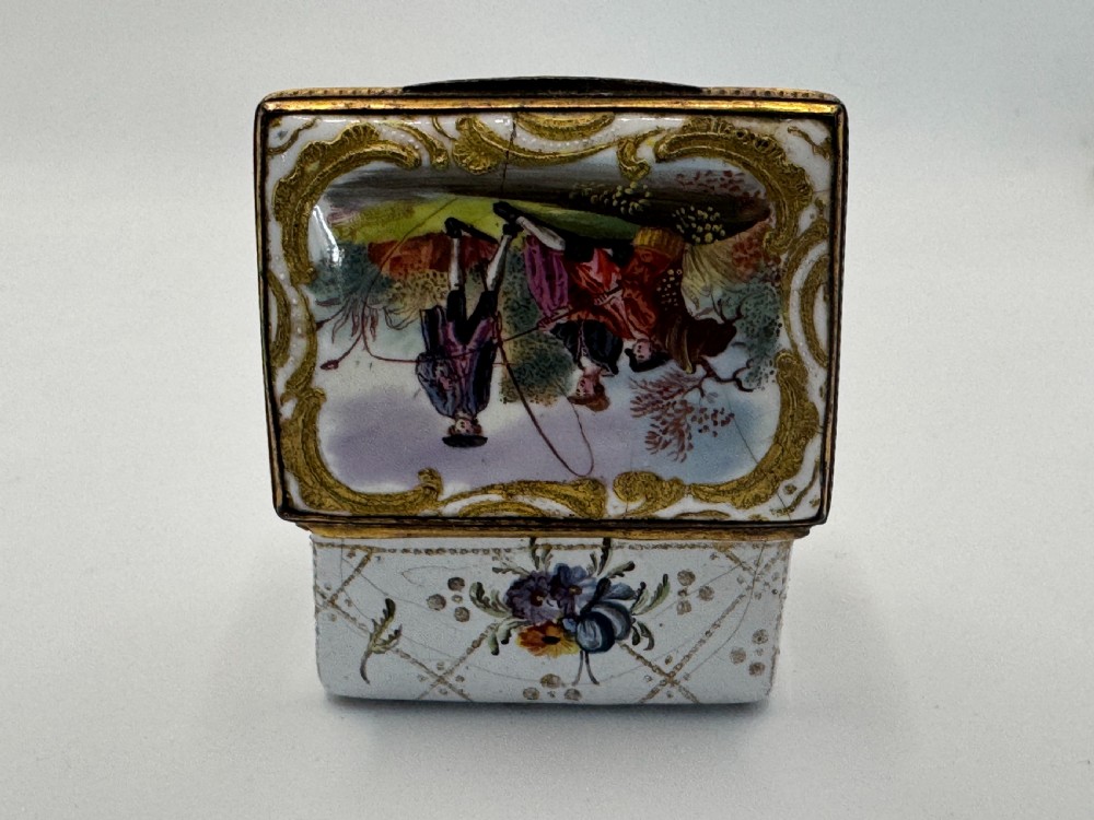 A small 19th-century rectangular enamel box decorated with a hand-painted pastoral scene surrounded by gilt scrollwork. View IX