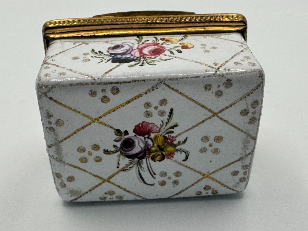 A small 19th-century rectangular enamel box decorated with a hand-painted pastoral scene surrounded by gilt scrollwork. View XI
