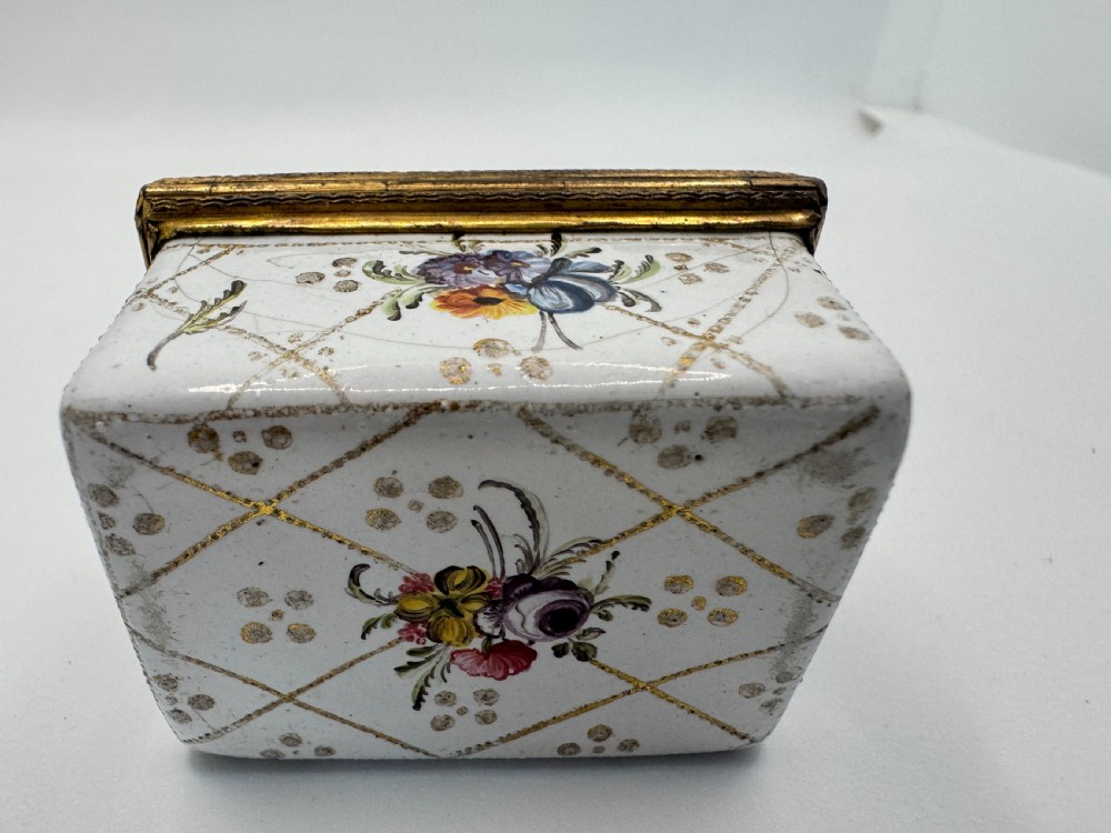 A small 19th-century rectangular enamel box decorated with a hand-painted pastoral scene surrounded by gilt scrollwork. View XII