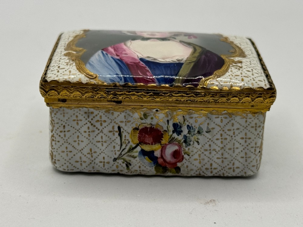An 18th-century rectangular Bilston enamel box featuring a hand-painted portrait on the lid and floral motifs on white patterned sides. View III