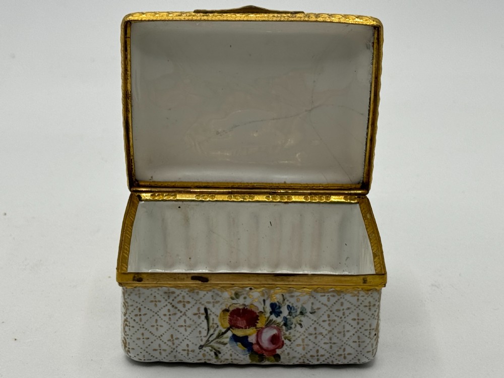 An 18th-century rectangular Bilston enamel box featuring a hand-painted portrait on the lid and floral motifs on white patterned sides. View VI