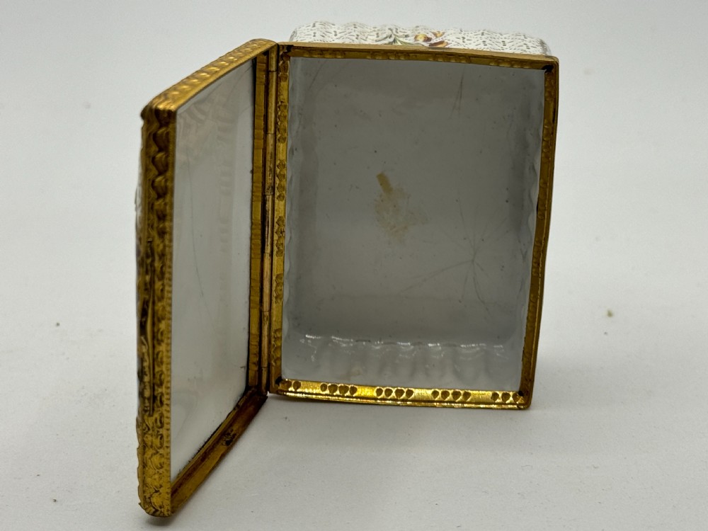 An 18th-century rectangular Bilston enamel box featuring a hand-painted portrait on the lid and floral motifs on white patterned sides. View VII