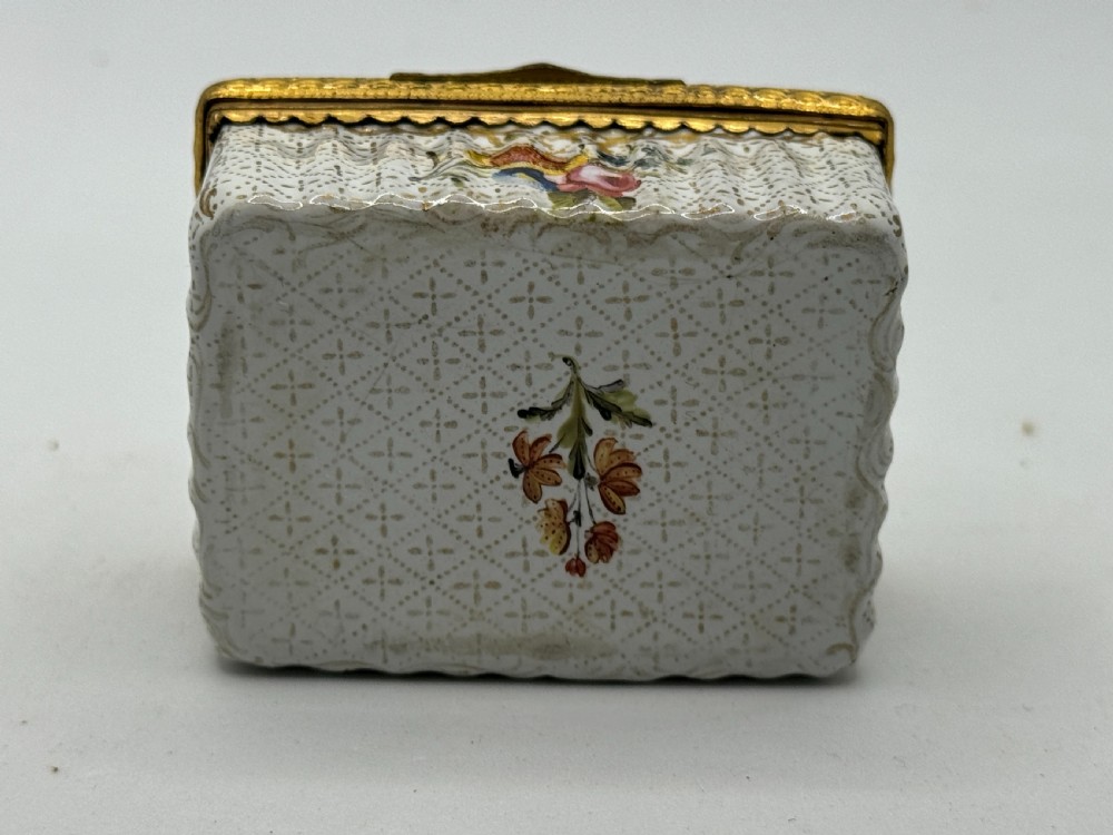 An 18th-century rectangular Bilston enamel box featuring a hand-painted portrait on the lid and floral motifs on white patterned sides. View VIII