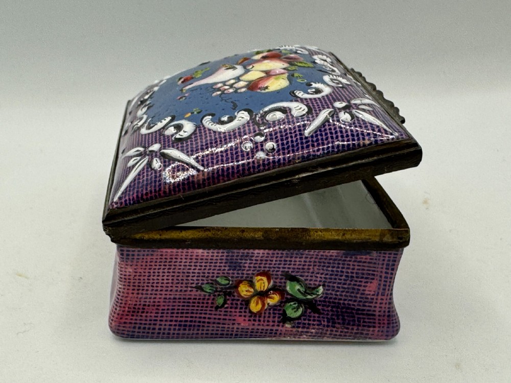 A rectangular eighteenth-century enamel box decorated with a central painted bird and fruit motif framed by white scrollwork against a purple lattice background. View VIII