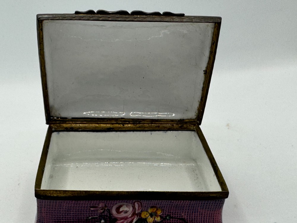 A rectangular eighteenth-century enamel box decorated with a central painted bird and fruit motif framed by white scrollwork against a purple lattice background. View XI
