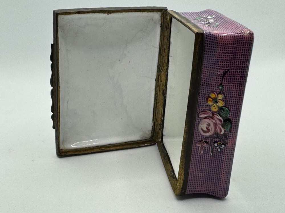 A rectangular eighteenth-century enamel box decorated with a central painted bird and fruit motif framed by white scrollwork against a purple lattice background. View XIII