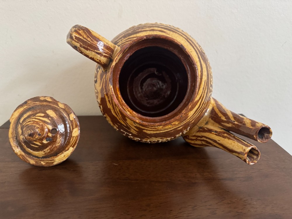 An Edwardian brown and cream marbled agateware teapot featuring twin spouts, a matching finial lid, and an inscribed date reading Todmorden Dec 1906. View XIII