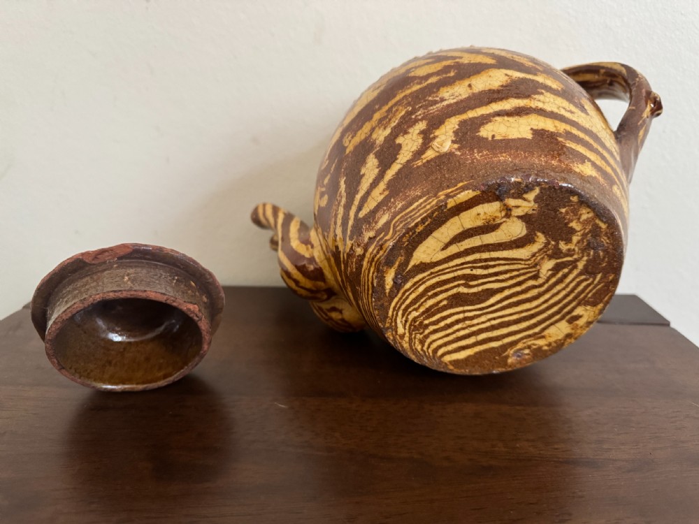 An Edwardian brown and cream marbled agateware teapot featuring twin spouts, a matching finial lid, and an inscribed date reading Todmorden Dec 1906. View XIV