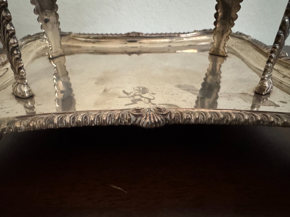 A Georgian sterling silver egg cruet stand holding six gilt-lined silver egg cups on a raised tray base with a central handle. View VI