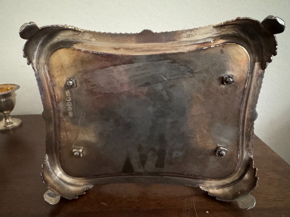 A Georgian sterling silver egg cruet stand holding six gilt-lined silver egg cups on a raised tray base with a central handle. View VII