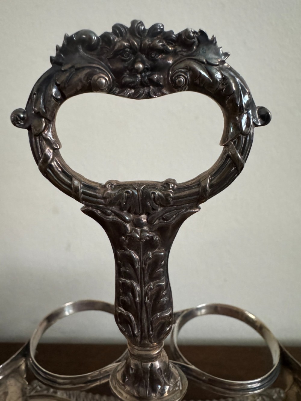 A Georgian sterling silver egg cruet stand holding six gilt-lined silver egg cups on a raised tray base with a central handle. View IX