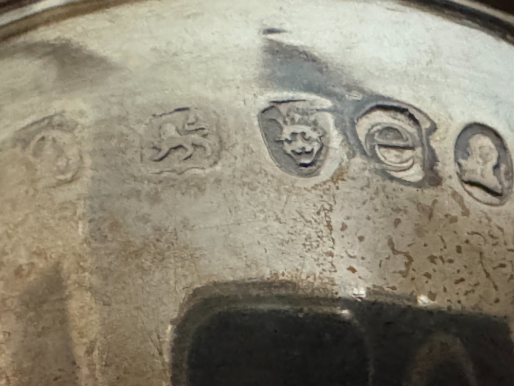 A Georgian sterling silver egg cruet stand holding six gilt-lined silver egg cups on a raised tray base with a central handle. View XII