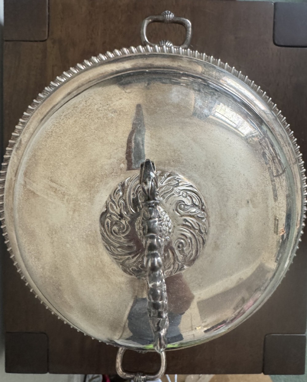 A George III sterling silver domed supper dish featuring cast handles, gadrooned borders, and a matching stand supported by paw feet. View IX