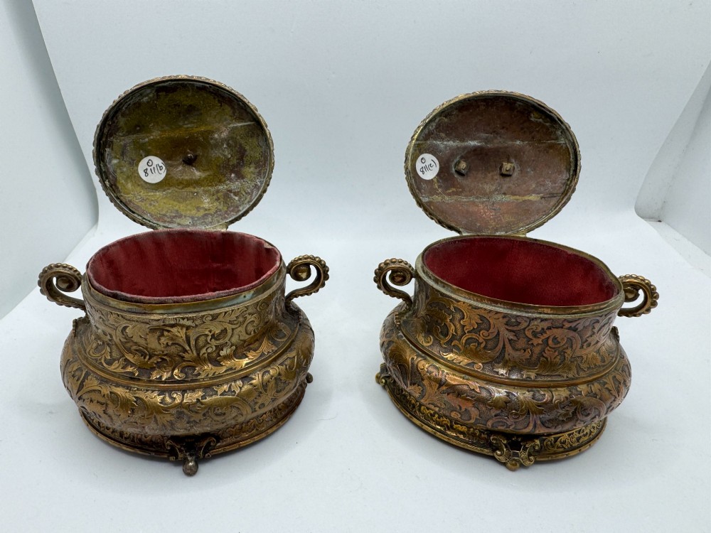 A pair of nineteenth-century gilt-metal jewellery caskets with acanthus leaf relief carving, side handles, and dog finials on the lids. View II