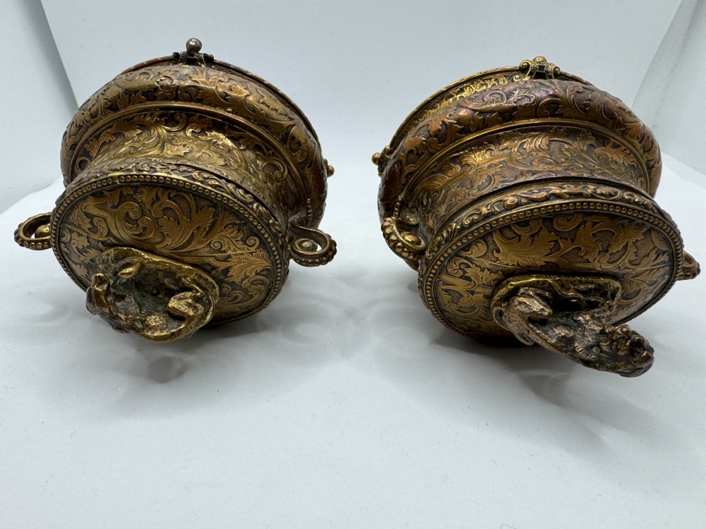 A pair of nineteenth-century gilt-metal jewellery caskets with acanthus leaf relief carving, side handles, and dog finials on the lids. View IV