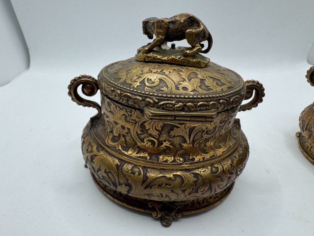 A pair of nineteenth-century gilt-metal jewellery caskets with acanthus leaf relief carving, side handles, and dog finials on the lids. View VIII