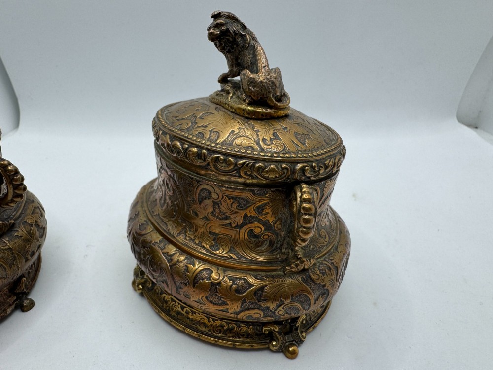 A pair of nineteenth-century gilt-metal jewellery caskets with acanthus leaf relief carving, side handles, and dog finials on the lids. View XII