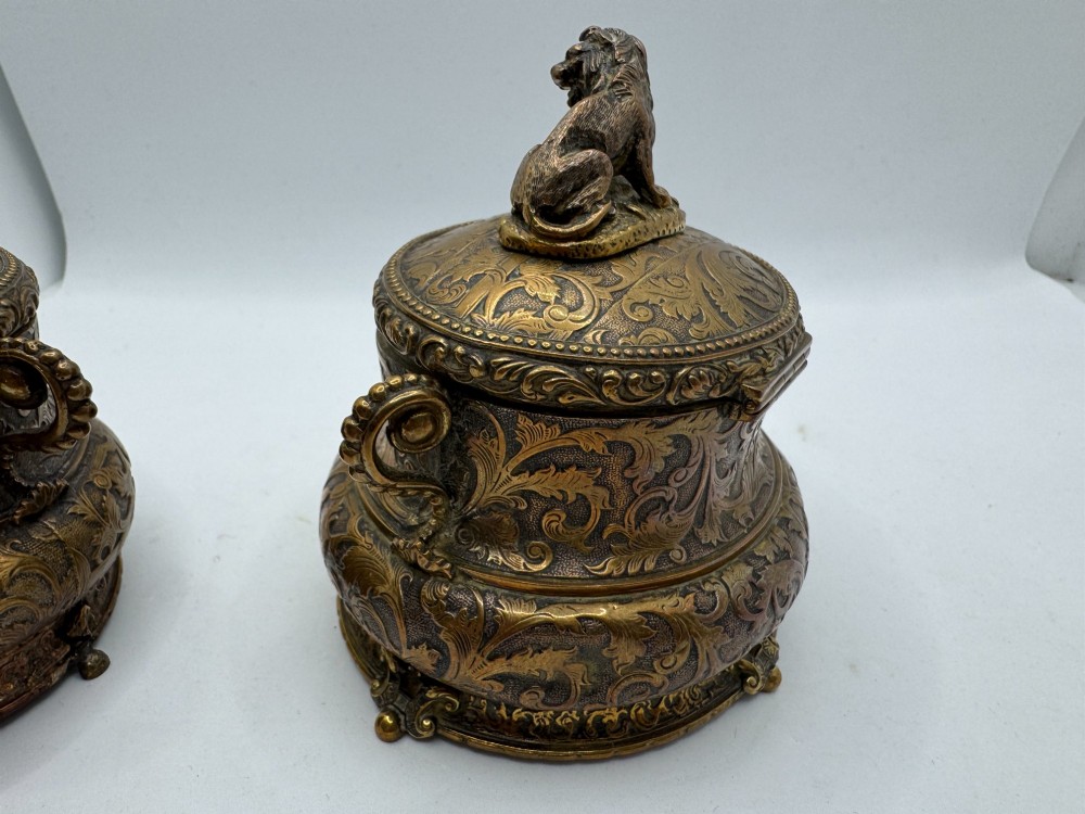 A pair of nineteenth-century gilt-metal jewellery caskets with acanthus leaf relief carving, side handles, and dog finials on the lids. View XIII