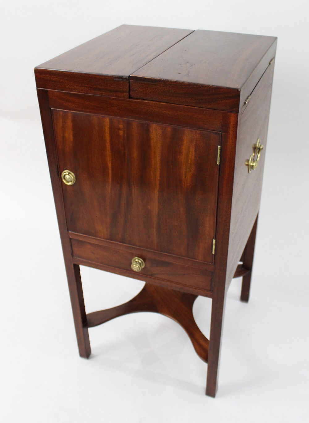 A George III mahogany vanity stand featuring a split folding top, a single cupboard door with a brass ring handle, a drawer, and an X-frame lower stretcher. View III