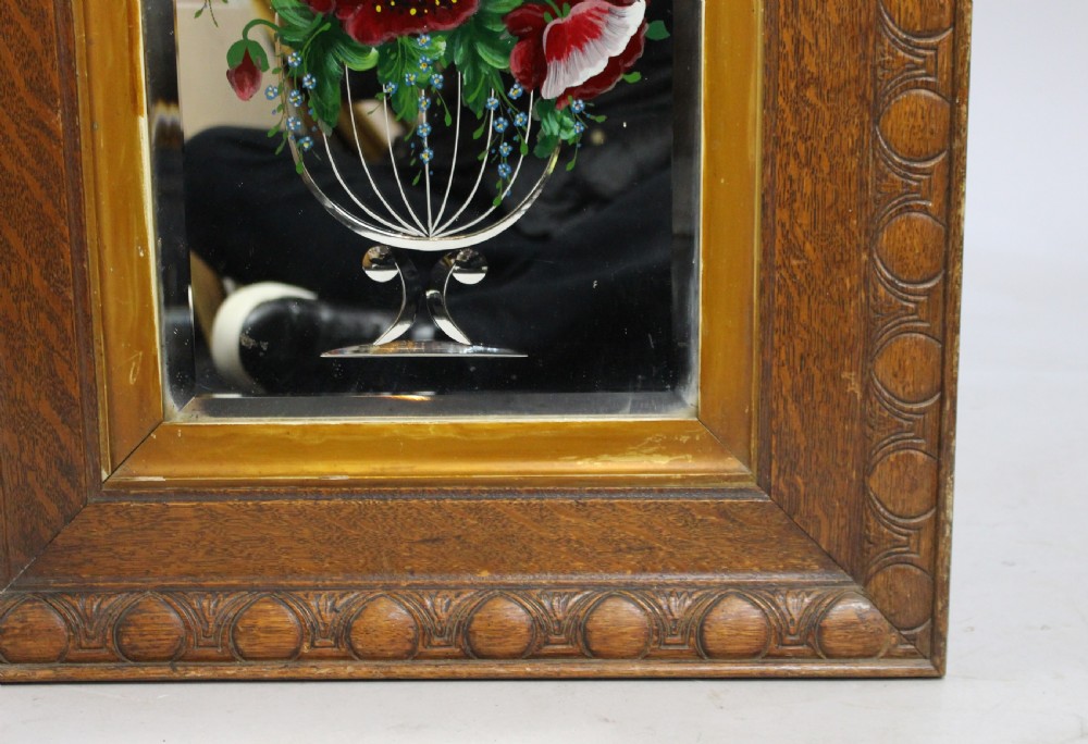 A rectangular Victorian mirror featuring hand-painted floral motifs and a butterfly on the glass, encased within a gilded slip and a carved oak frame. View II