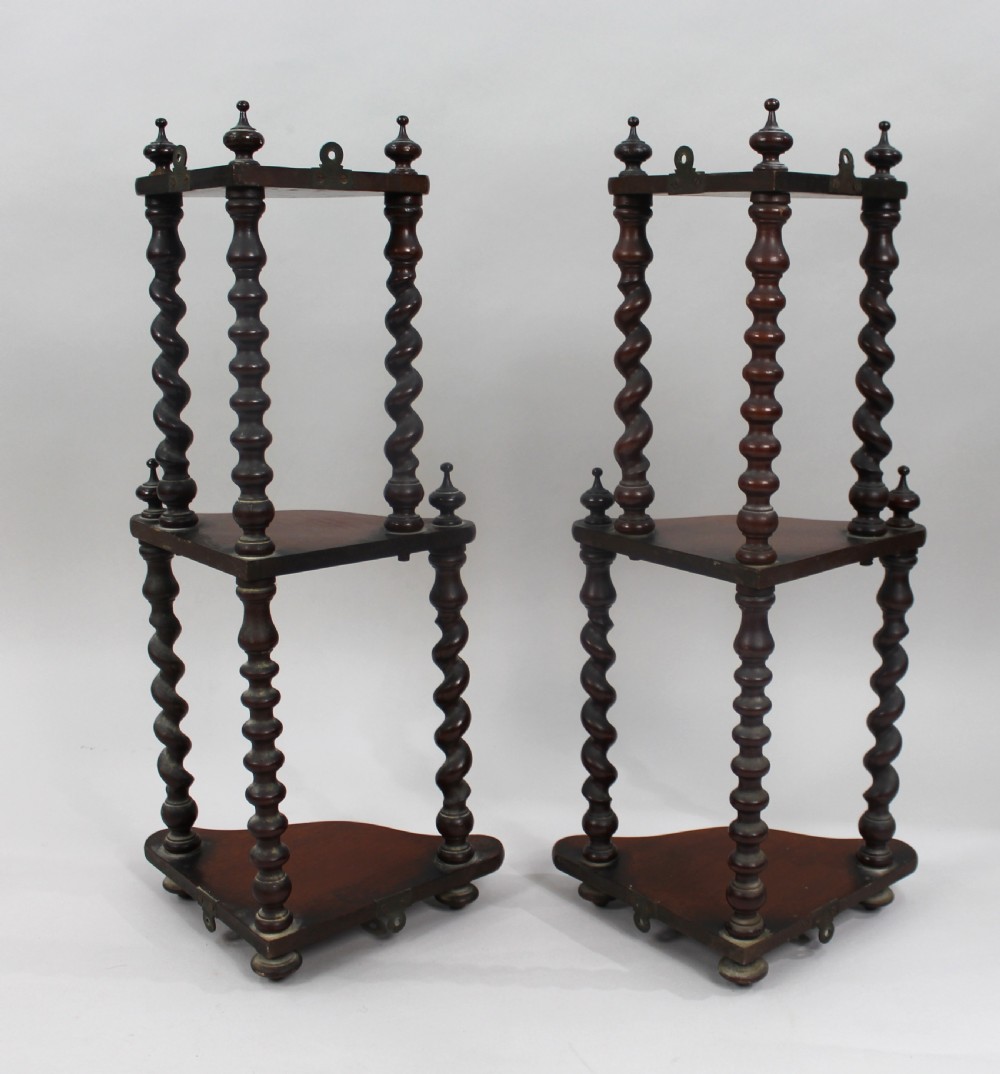 A pair of three-tiered dark mahogany corner shelves featuring barley twist turned pillars and top finials. View III