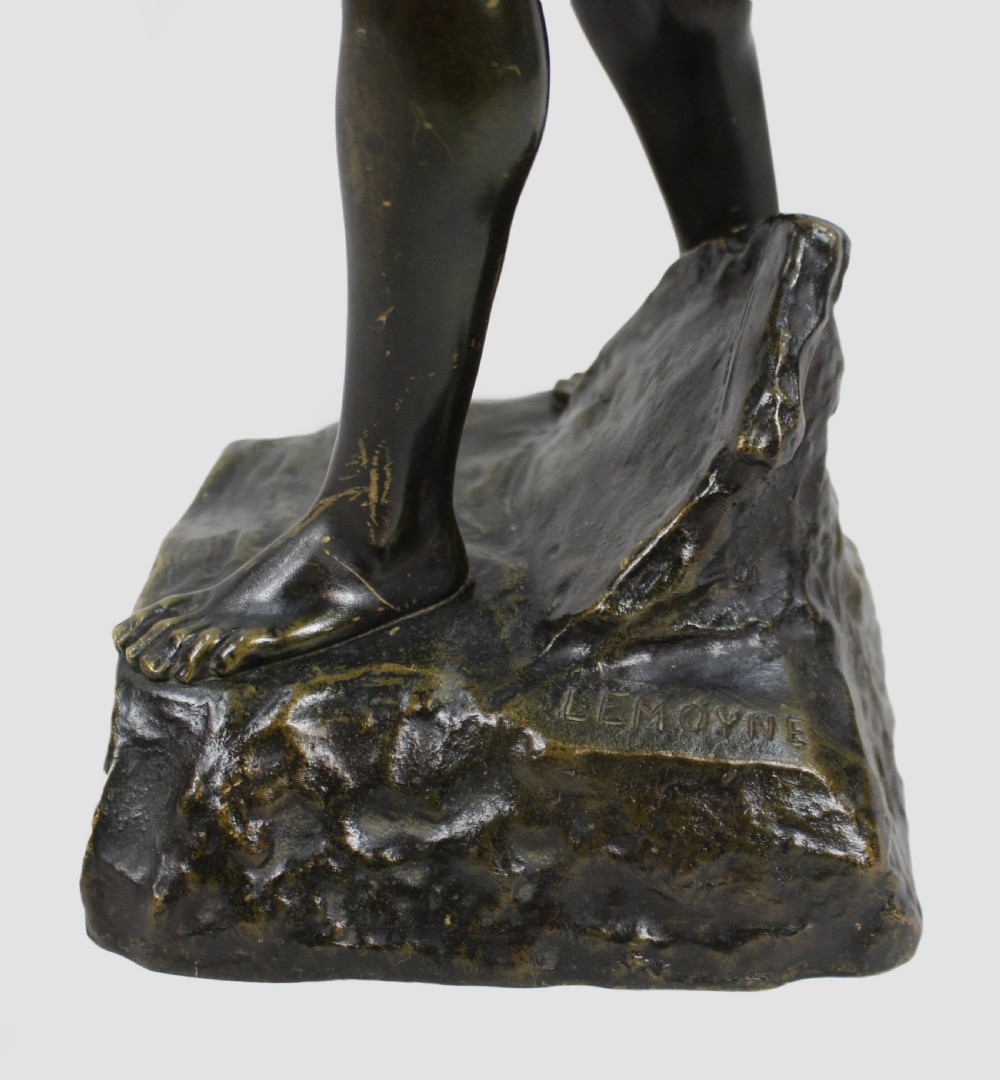 A dark patinated bronze sculpture depicting a standing classical male figure raising a laurel wreath in his right hand and holding a cup in his left hand. View XIII