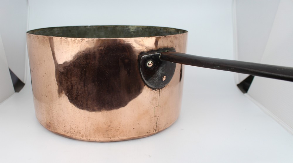 A large Georgian copper saucepan with a polished copper body, tin-lined interior, and a long black iron handle attached with rivets. View III