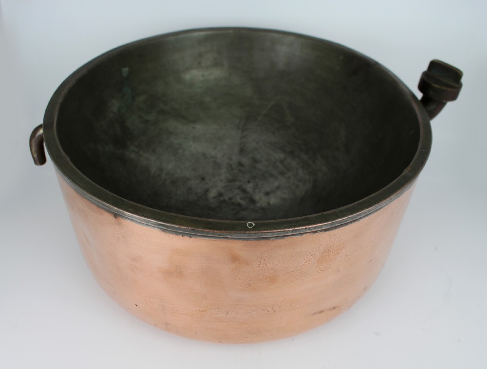 A large round antique copper bain marie pan featuring a dark tin-lined interior and side handles. View II
