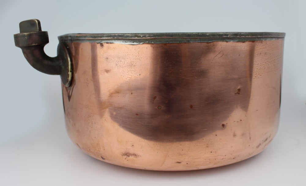 A large round antique copper bain marie pan featuring a dark tin-lined interior and side handles. View IV