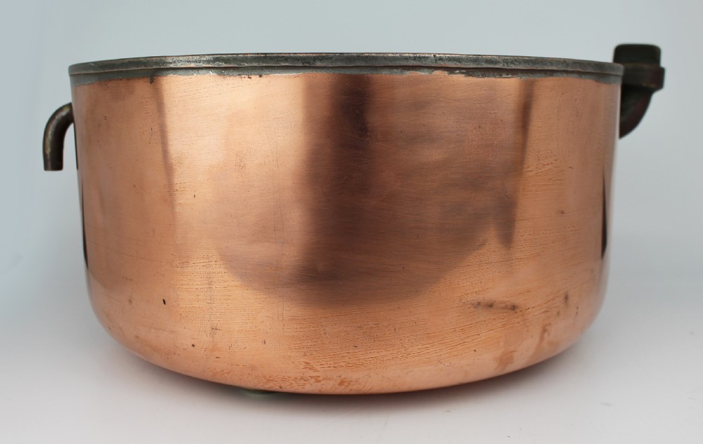A large round antique copper bain marie pan featuring a dark tin-lined interior and side handles. View VI