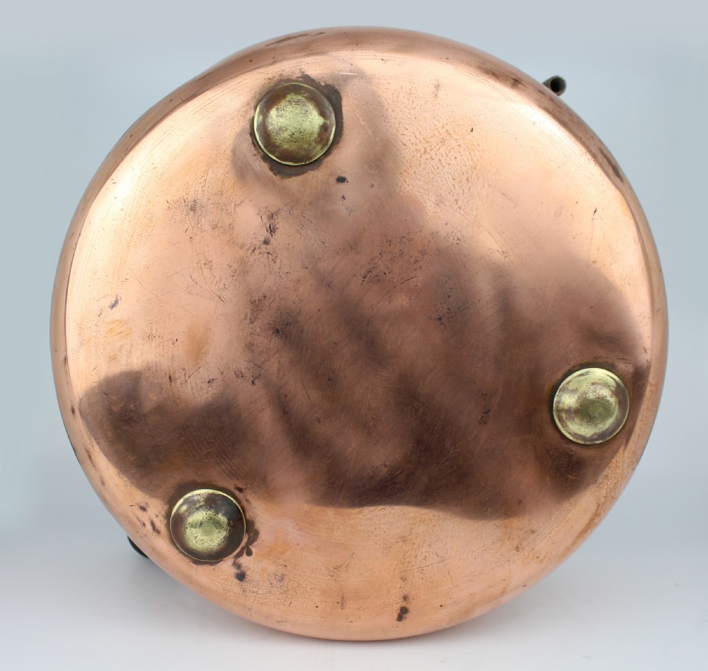 A large round antique copper bain marie pan featuring a dark tin-lined interior and side handles. View VII